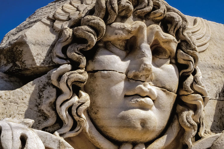 Face carved on marble in classical style by ancient greeks at the apollo's temple in didyma, turkey.