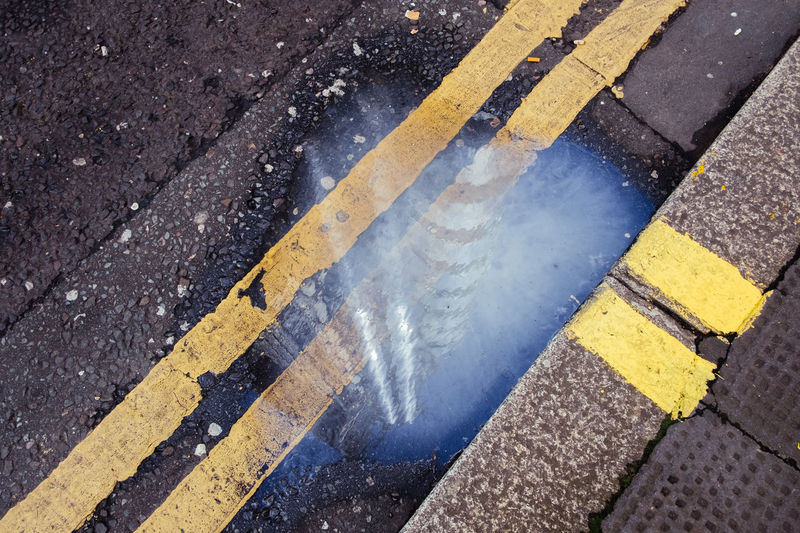 High angle view of road sign on wet street