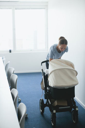 Woman with buggy in meeting room