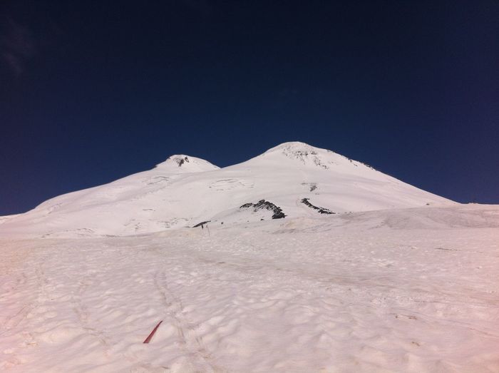 Scenic view of snowcapped mountains against clear blue sky