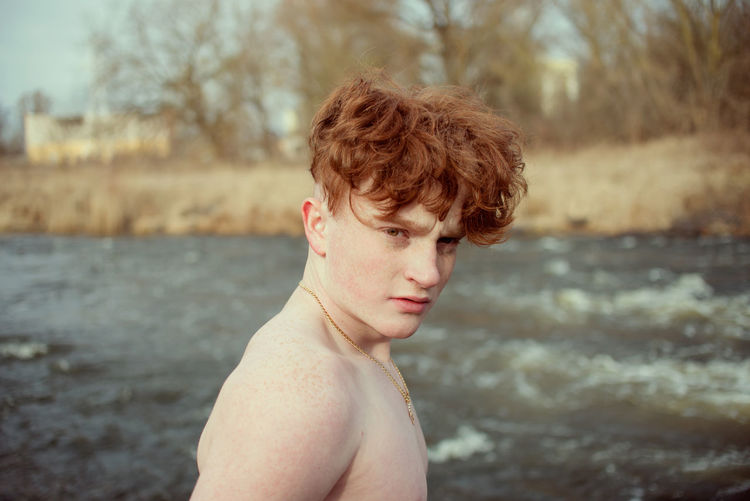 Portrait of shirtless man in river