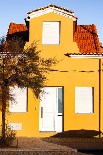 Exterior of yellow house against clear sky