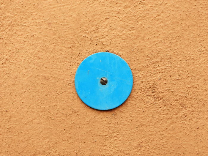 Circular plate mounted on orange wall