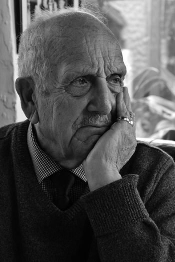 Close-up of senior man thoughtful man looking away