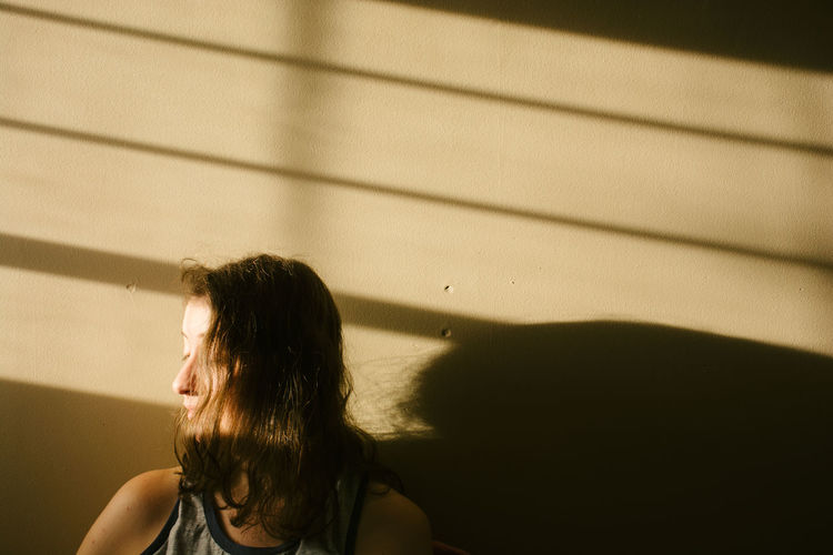 Portrait of woman sitting in sunlight