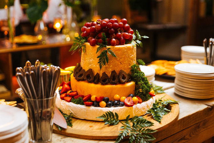 Fruits arranged on cheese at table in restaurant