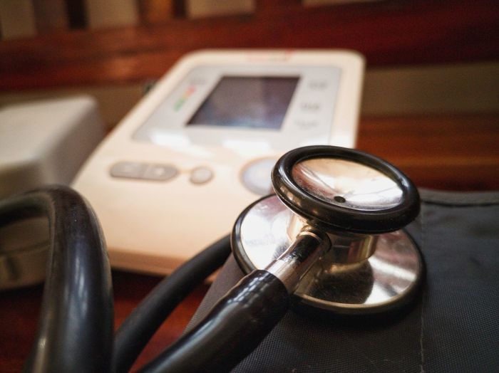 Close-up of stethoscope and medical equipment on table