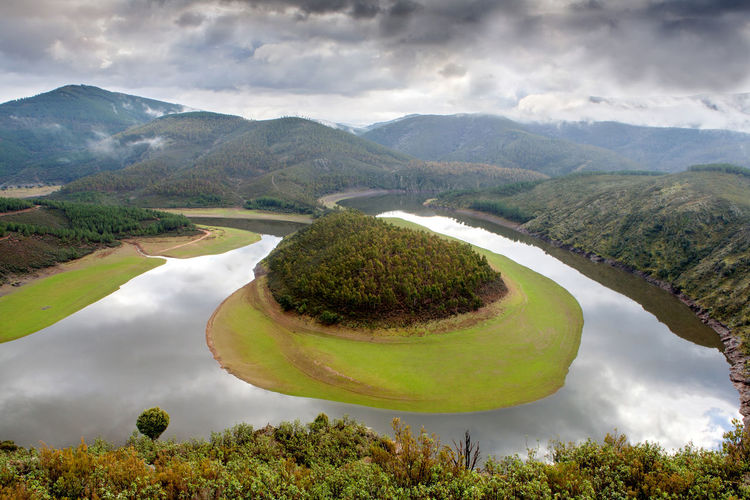 Scenic view of lake and mountains against sky