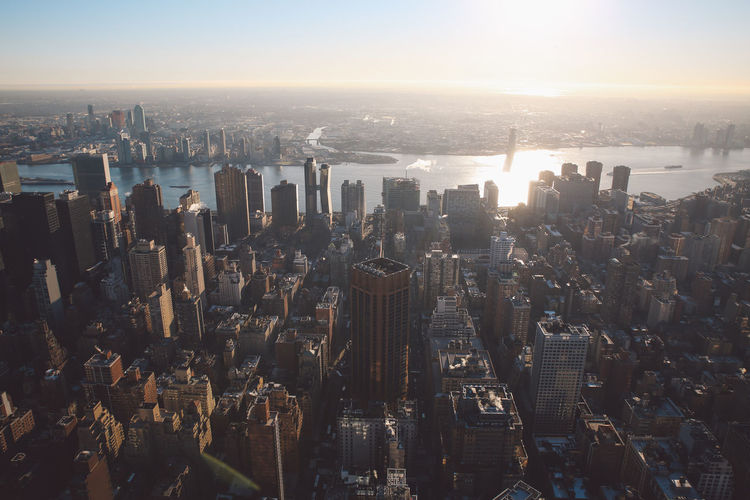 Aerial view of cityscape against sky during sunset