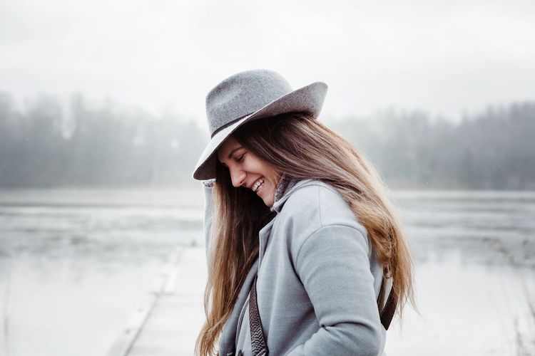 Woman wearing hat standing in snow
