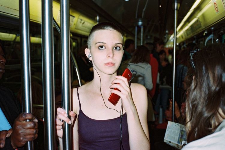 Portrait of young woman on bus