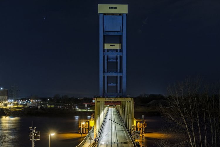 High angle view of bridge by harbor at night