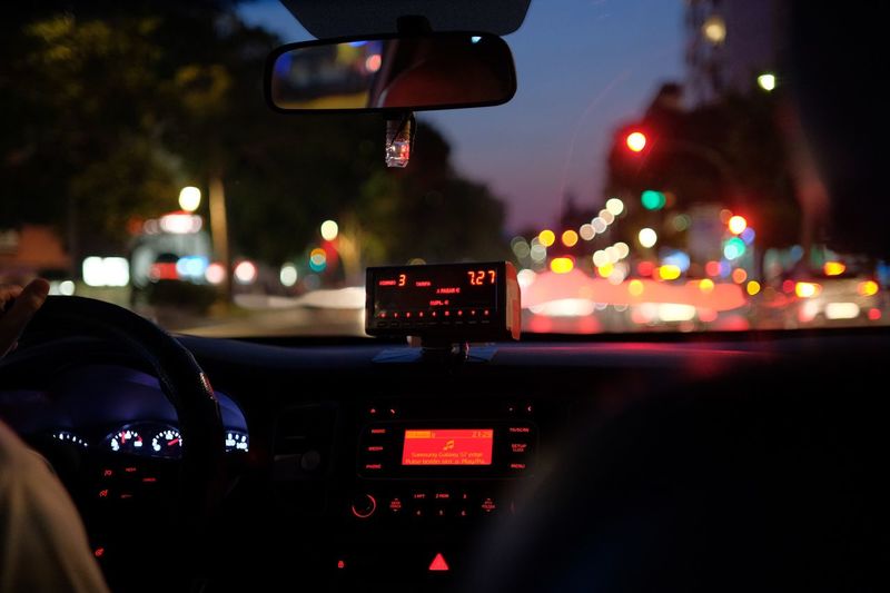 Illuminated car seen through windshield at night