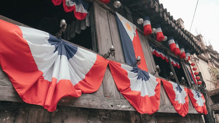Low angle view of flags hanging on building