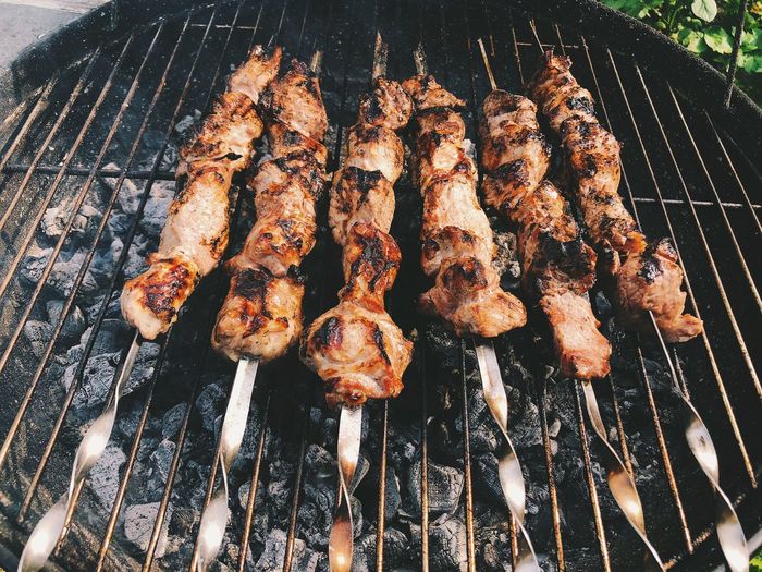 High angle view of meat on barbecue grill
