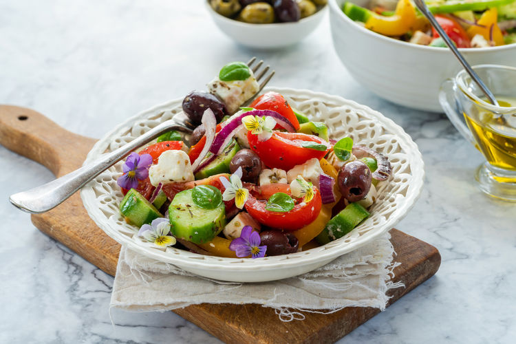 Traditional greek salad with fresh vegetables and feta cheese - healthy food idea