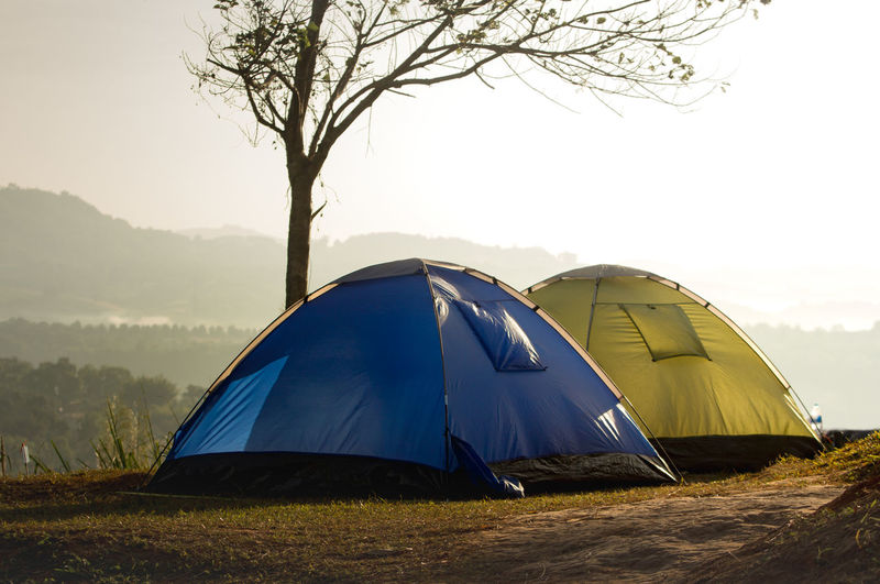 Tent on field against sky during sunset