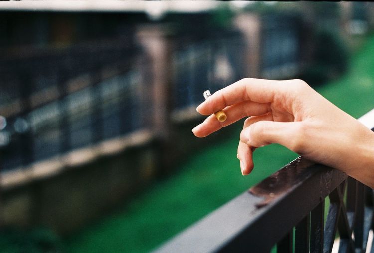 Person hand holding cigarette