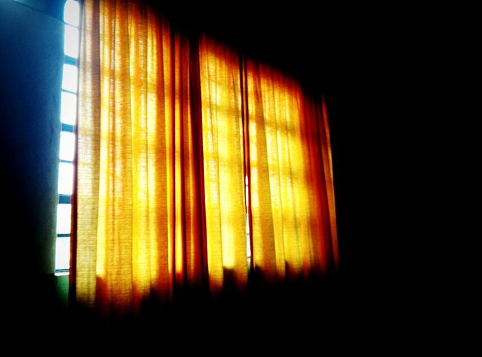 Yellow curtain on window