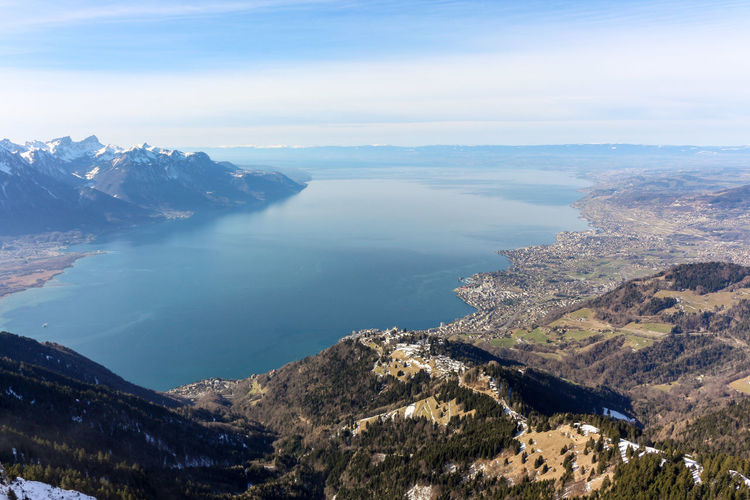 High angle view of sea and mountains against sky