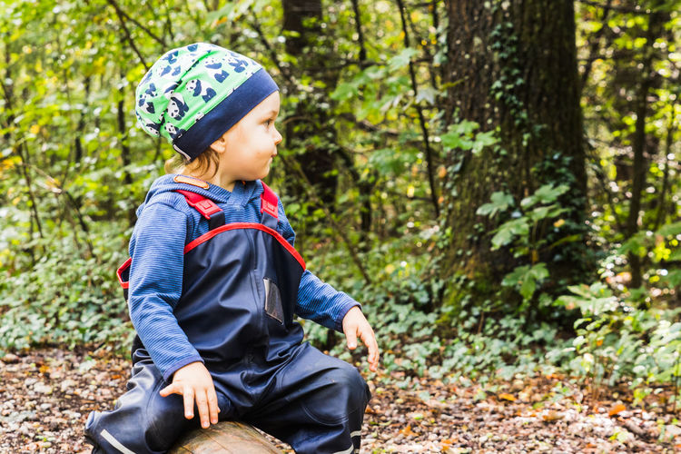 Boy looking away in forest