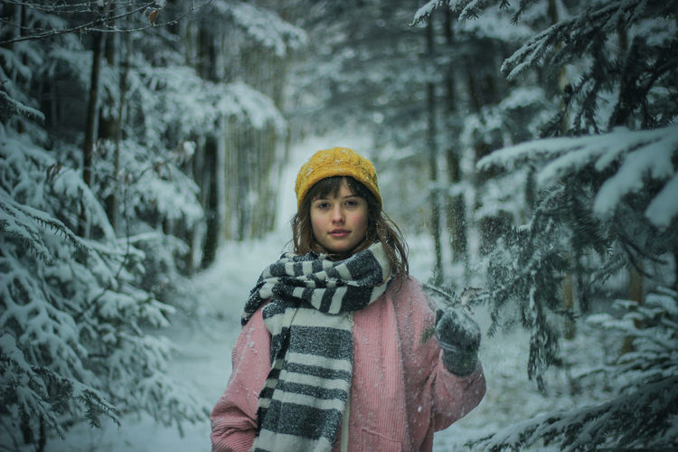 Girl in snow covered forest