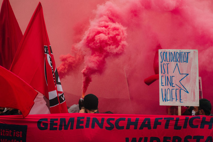 Close-up of antifa sign board with red smoke