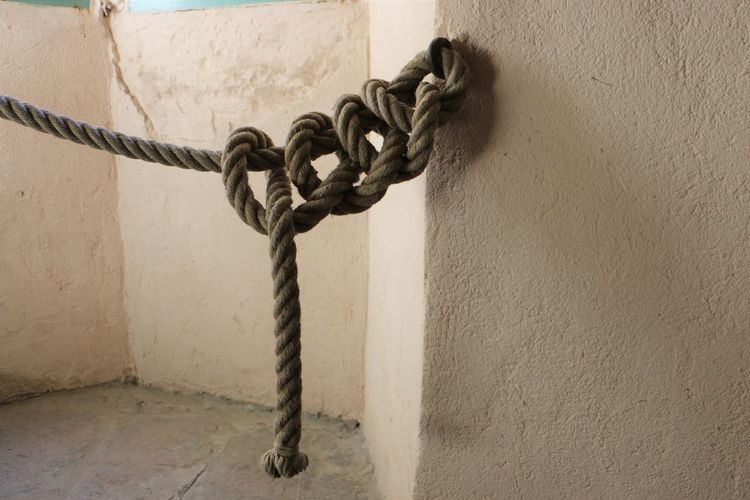 Close-up of chain hanging on wall