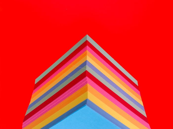 Triangle shape toys against red background