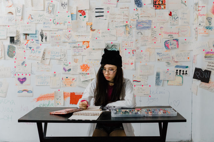 Woman drawing on paper