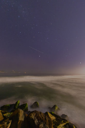 Scenic view of sea against sky at night