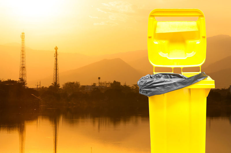 Digital composite image of yellow and water against orange sky