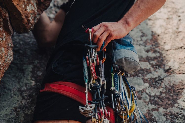 Midsection of man with safety harness