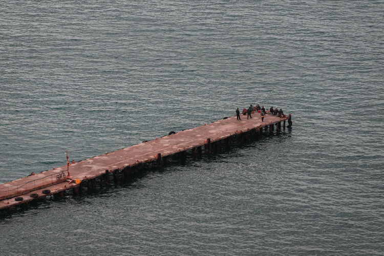 High angle view of people on pier over sea