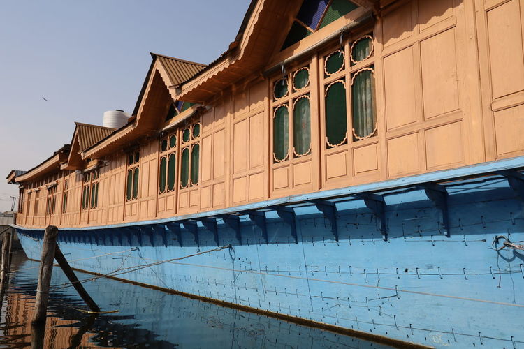 Low angle view of old houseboat against sky, dal lake srinagar kashmir 