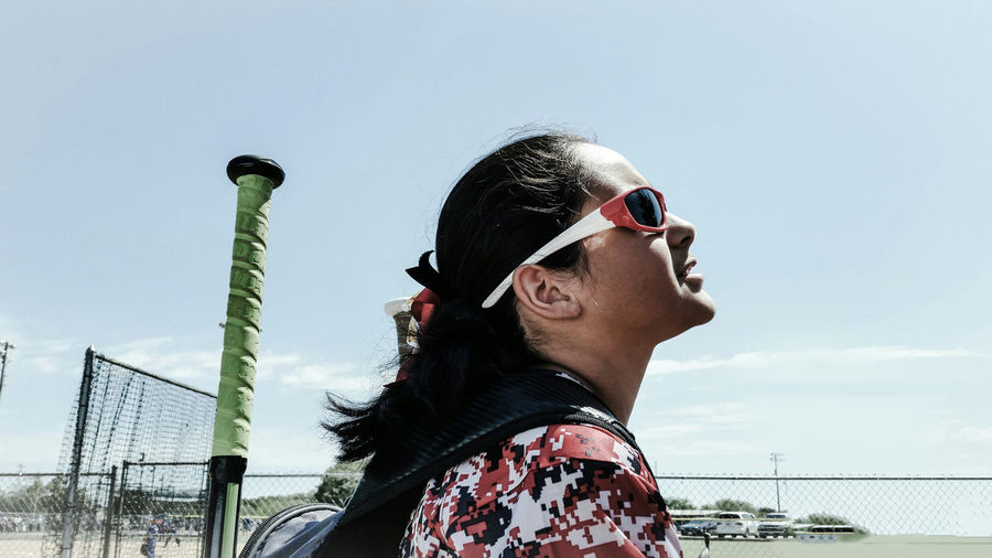 Young woman wearing sunglasses against sky