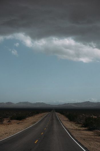 Empty road against sky