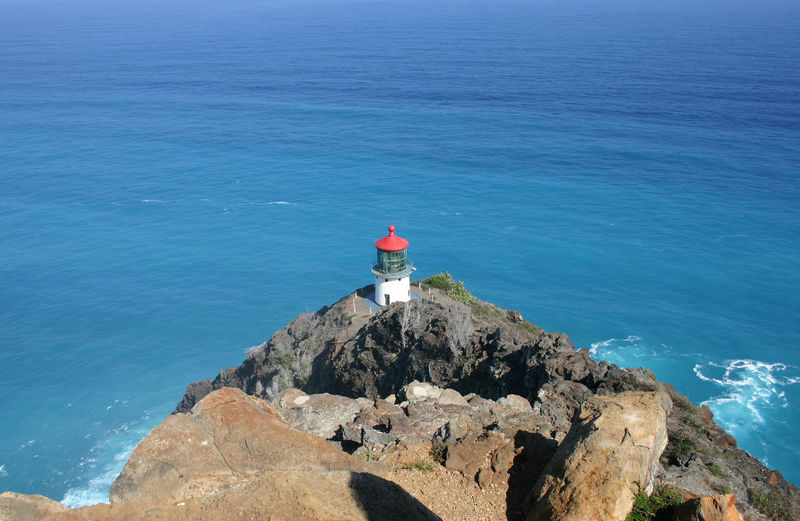 High angle view of old lighthouse on cliff