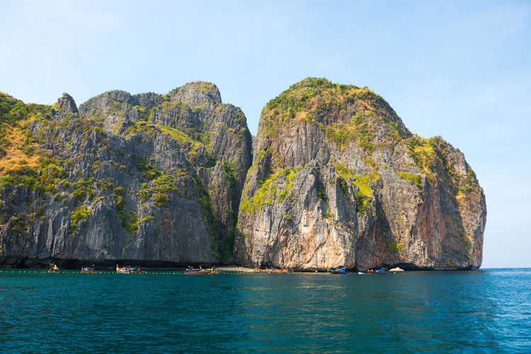 Panorama of famous phi phi island in thailand with sea, boats and mountains in beautiful lagoon