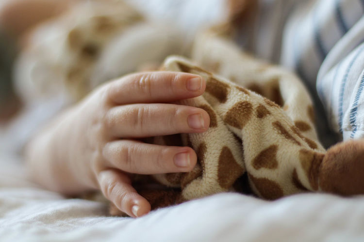 Midsection of boy lying on bed