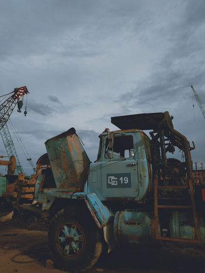 Abandoned truck on field against sky