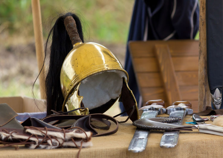 Close-up of old weapons on table