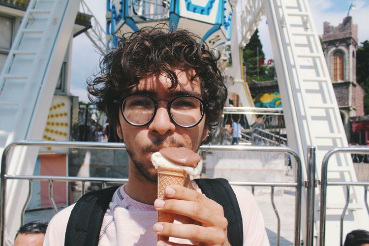 Portrait of young man eating ice cream cone