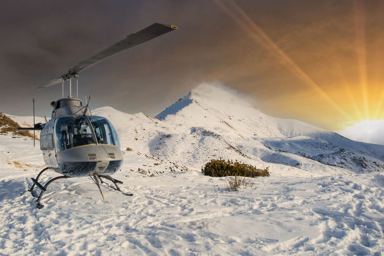Helicopter in the alps at sunset