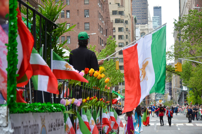 Low angle view of people in city during the persian day parade.